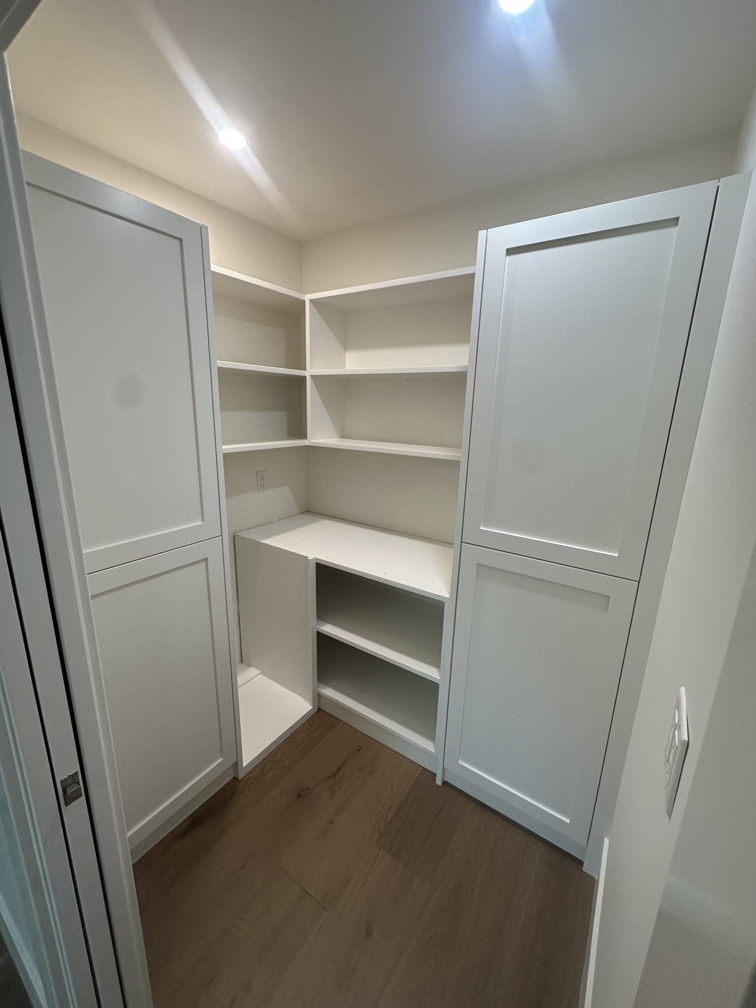 Gray painted pantry doors with white shelves