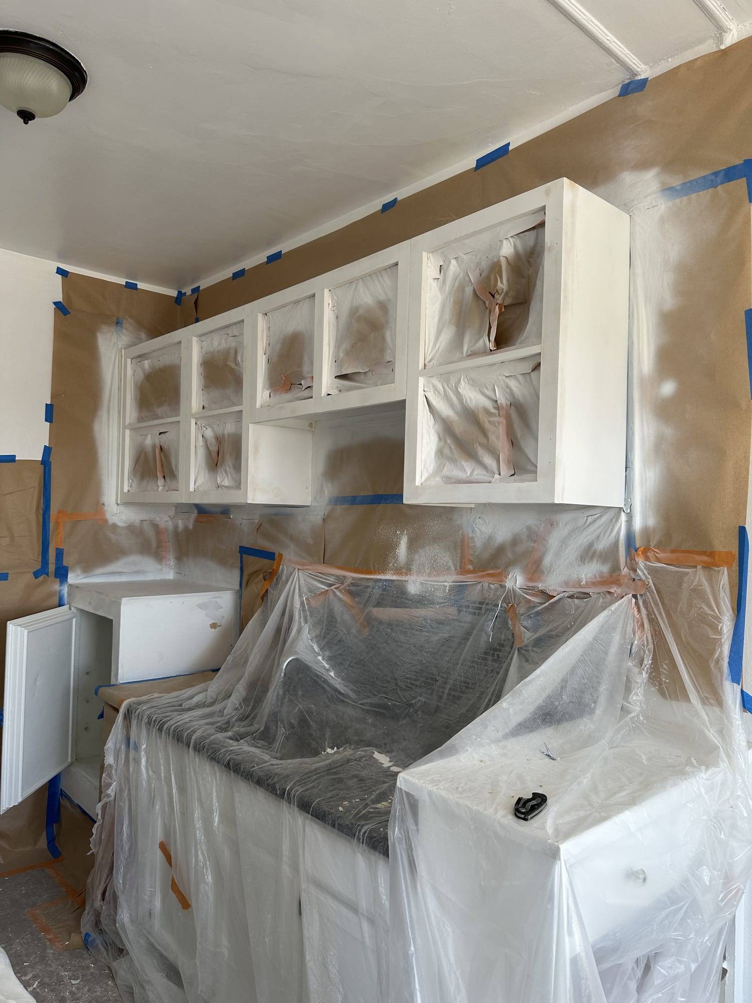 Kitchen masked in plastic for cabinet spraying