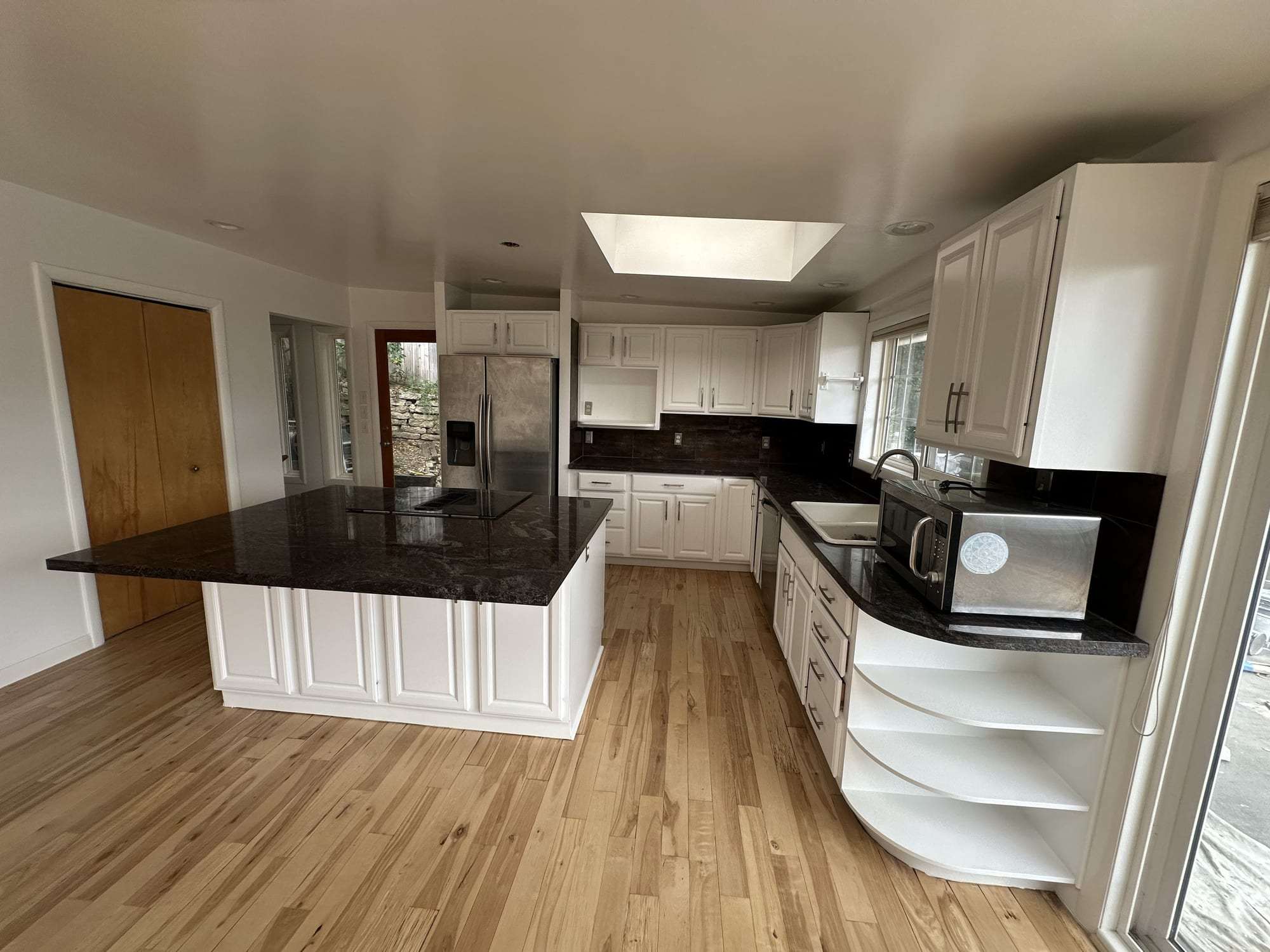 White painted kitchen cabinets and island, wide view