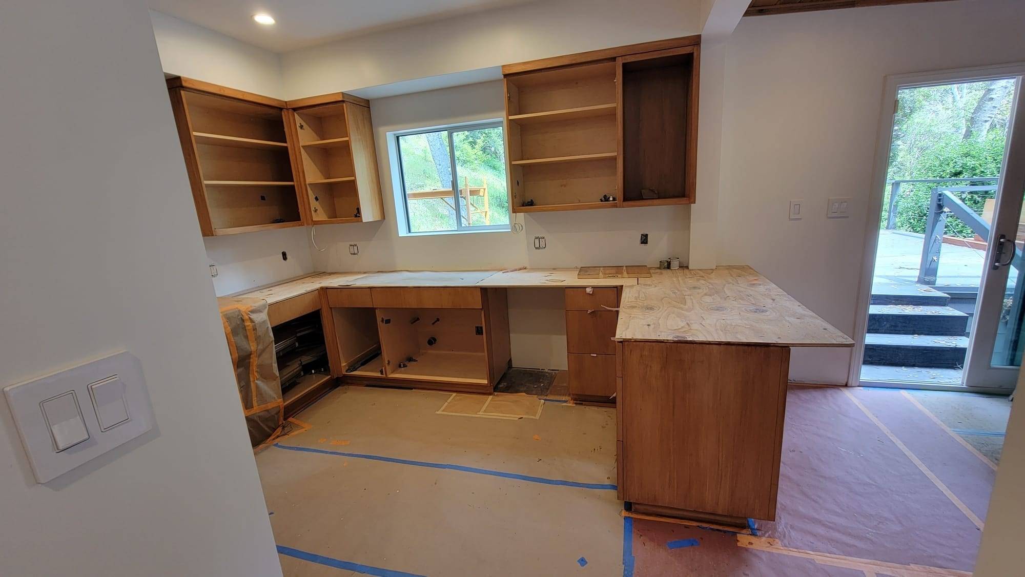 Wood kitchen cabinets with doors removed for refinishing