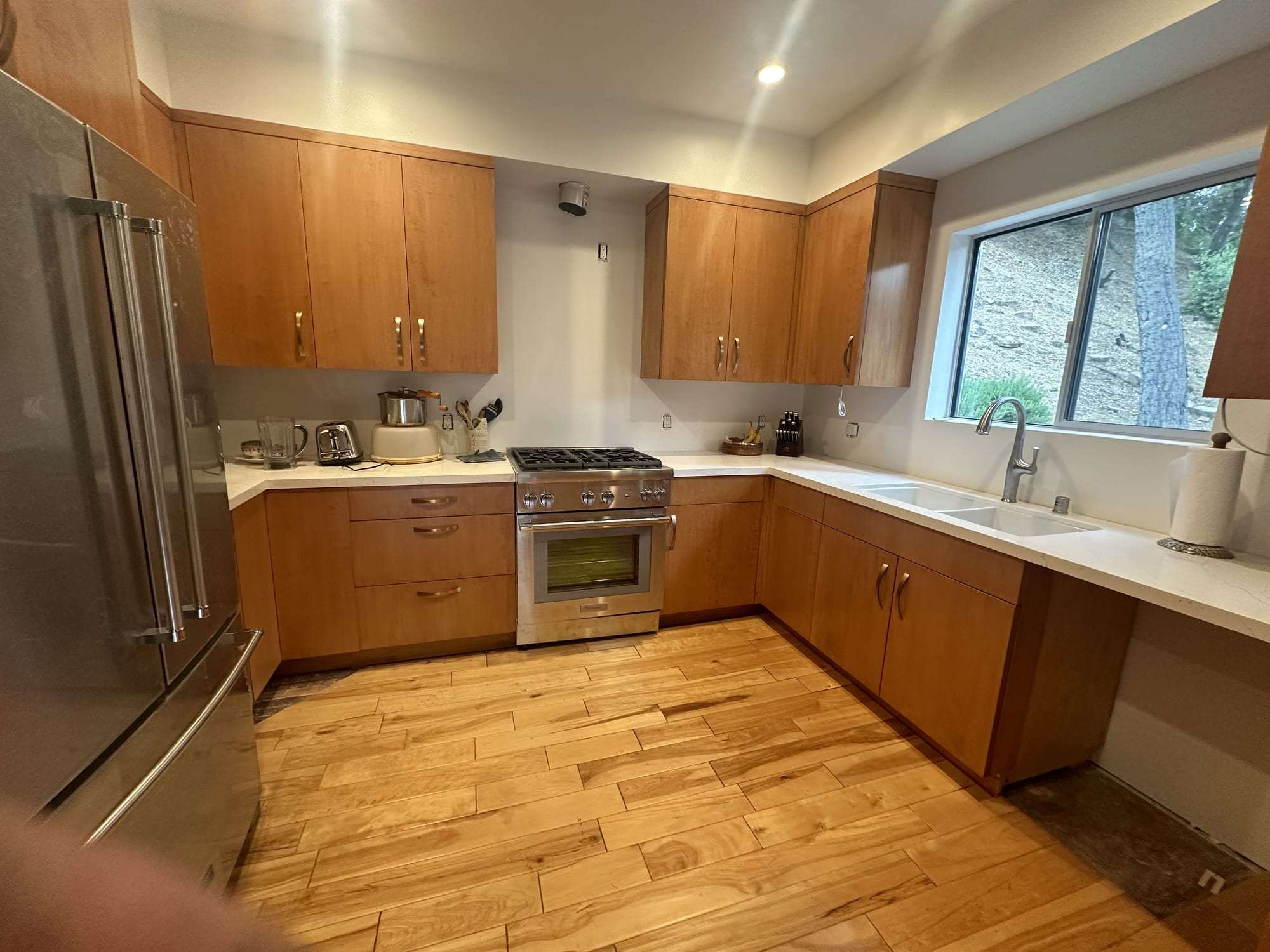 Natural wood stained kitchen cabinets, wide view