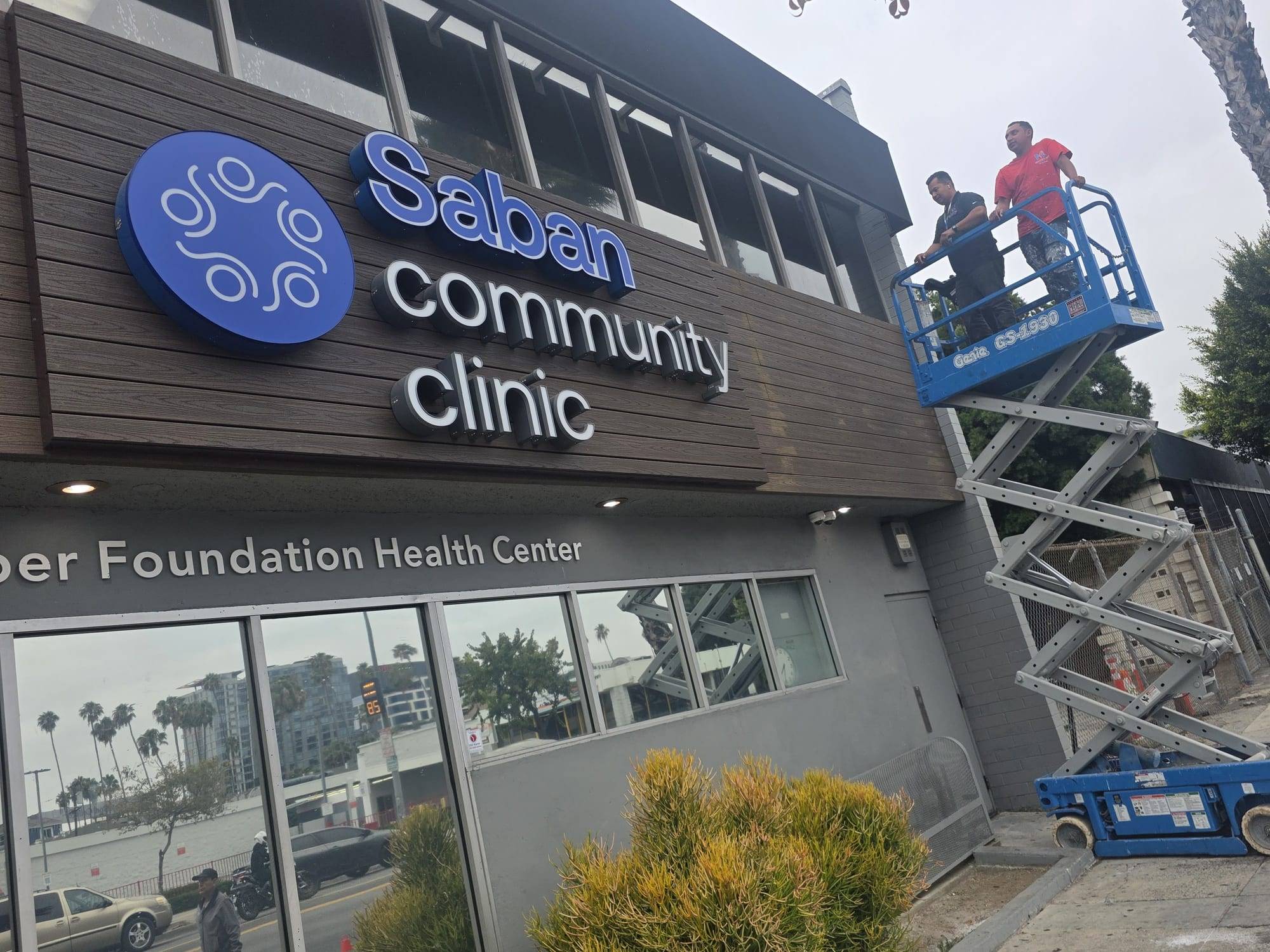 Master's Pro Painting crew on a lift repainting a medical clinic facade