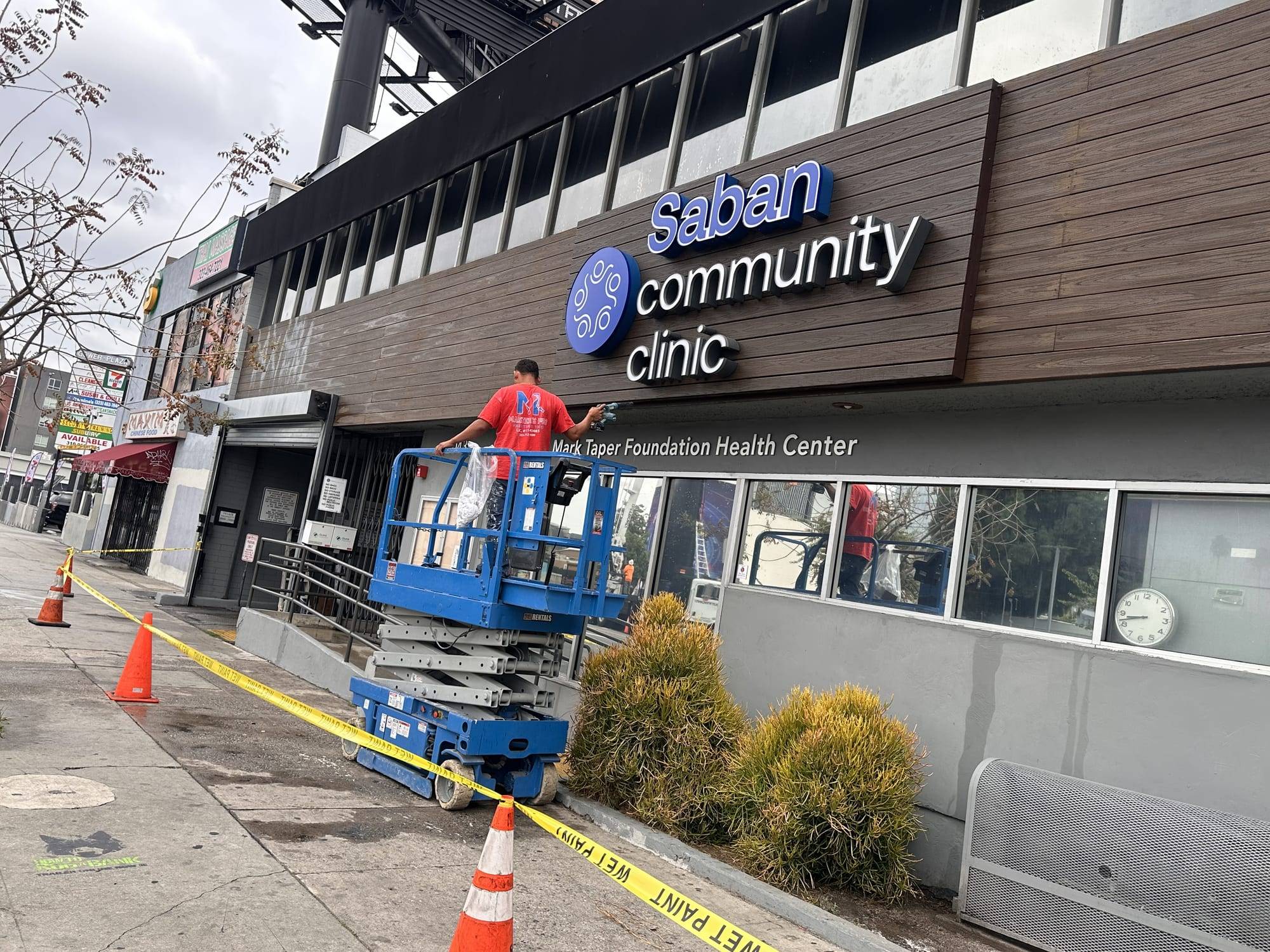Medical clinic facade repaint with a lift, street view