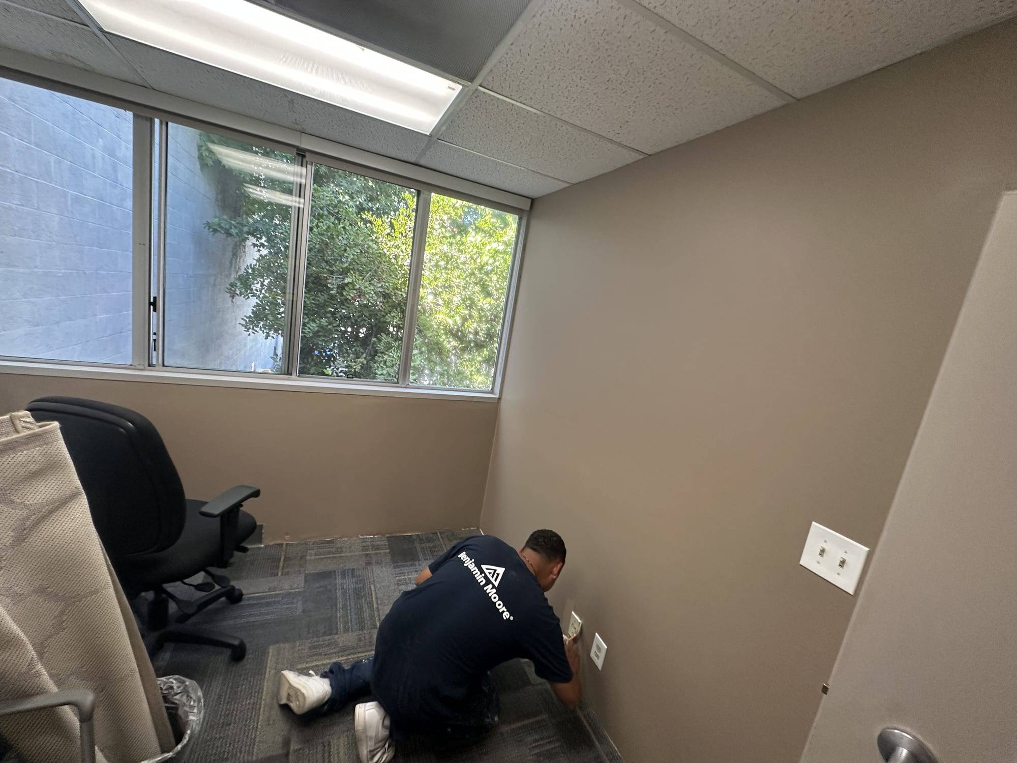 Painter prepping office walls