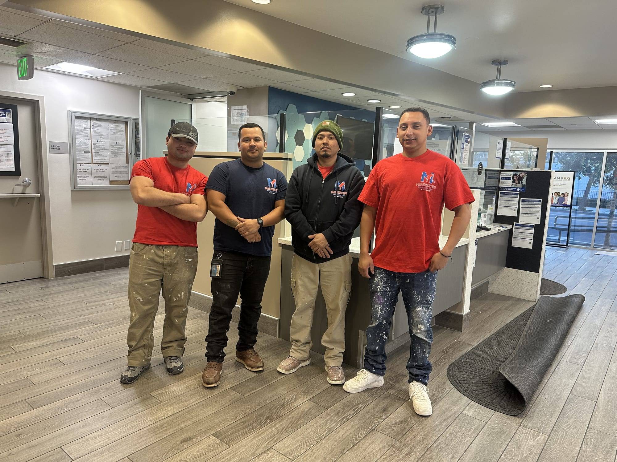 Four members of the Master's Pro Painting team at a paint store