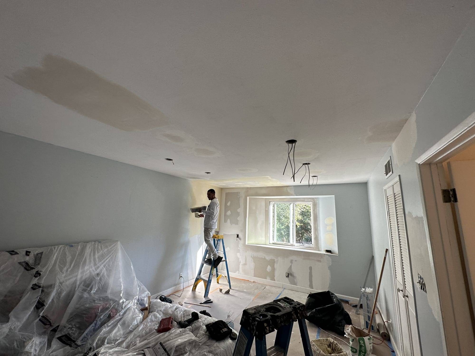 Ceiling drywall patches with the furniture covered