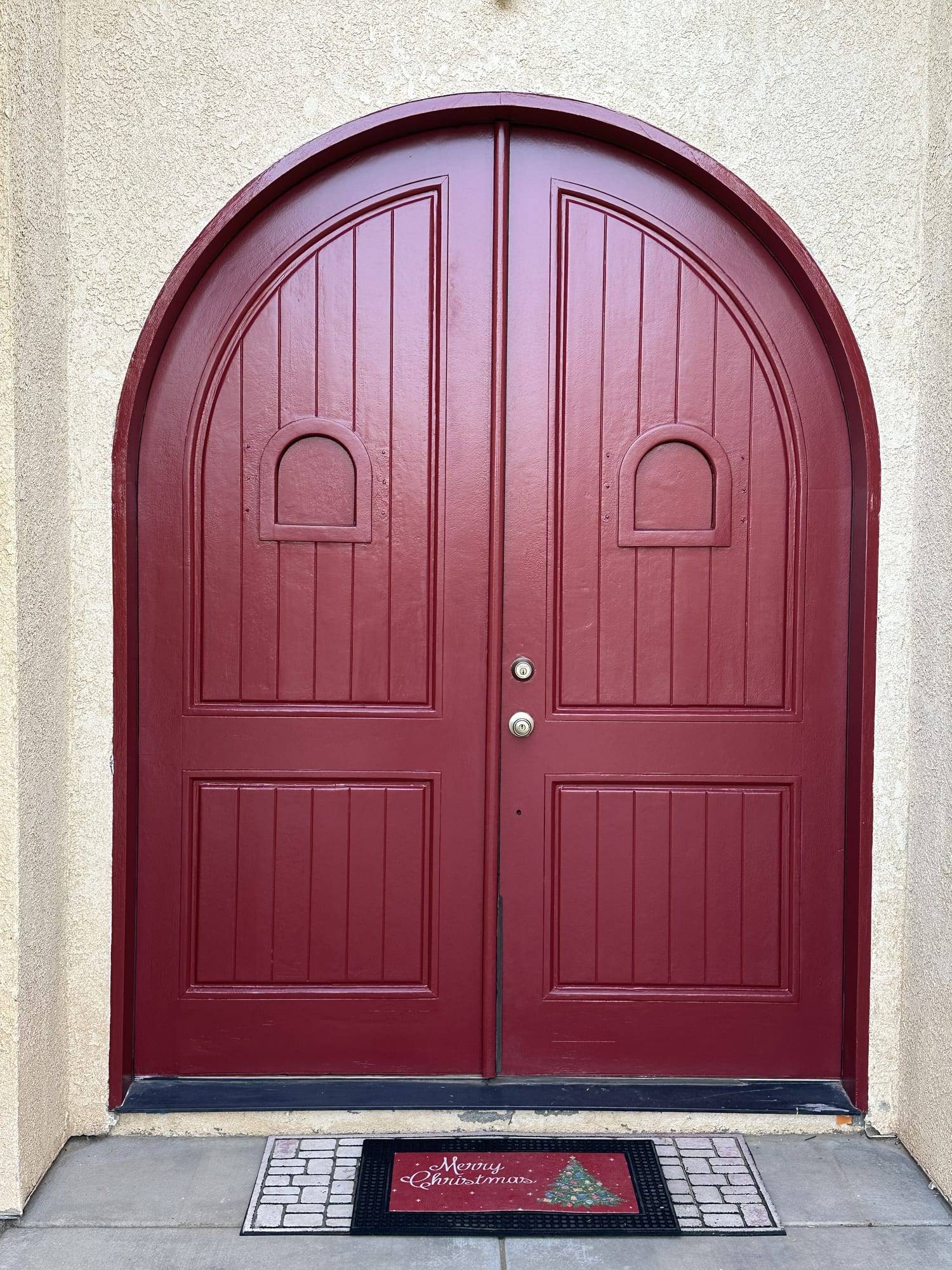 Arched double entry doors painted red