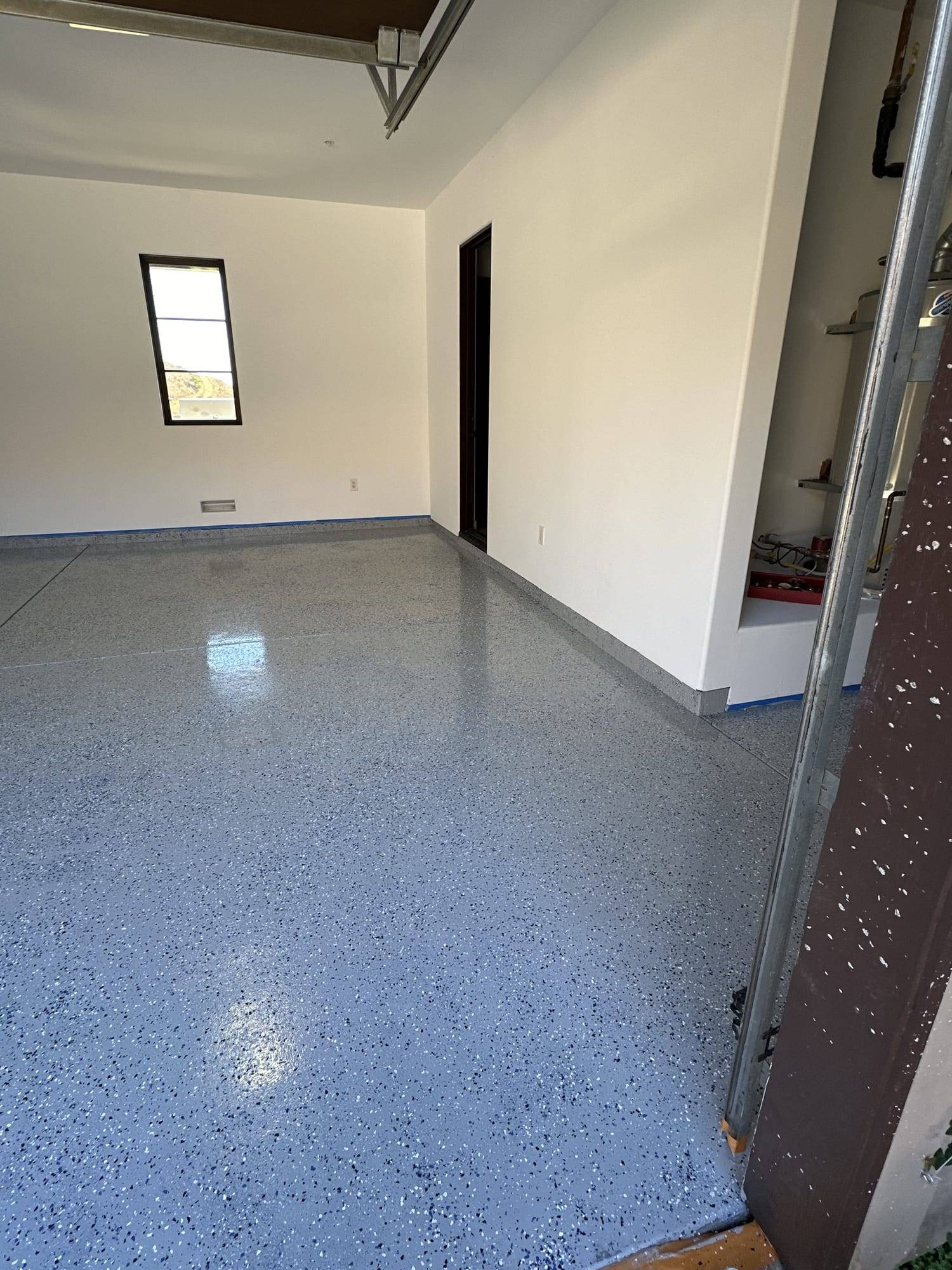 Gray flake epoxy floor seen through a doorway