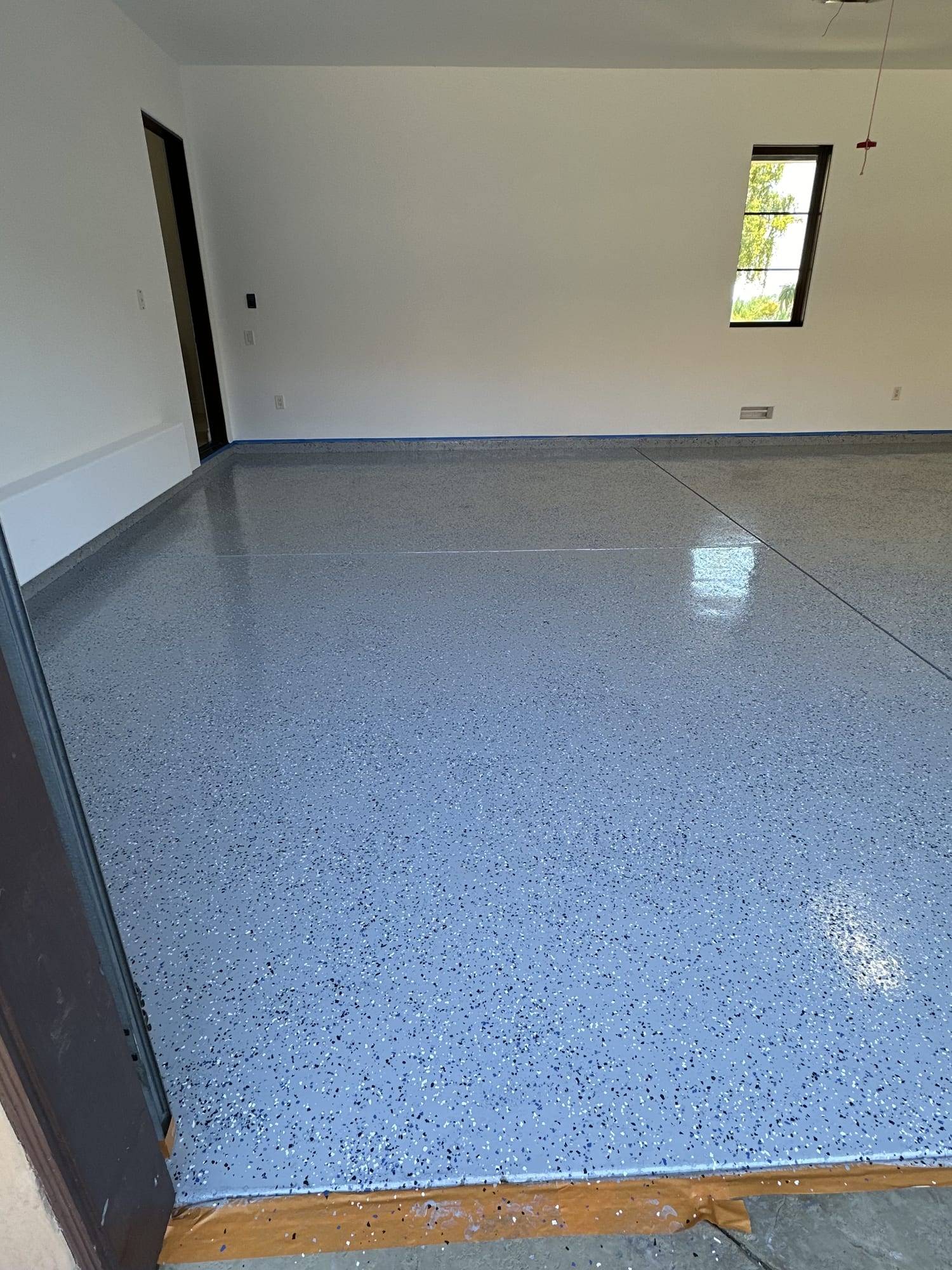 Gray flake epoxy floor beside a window