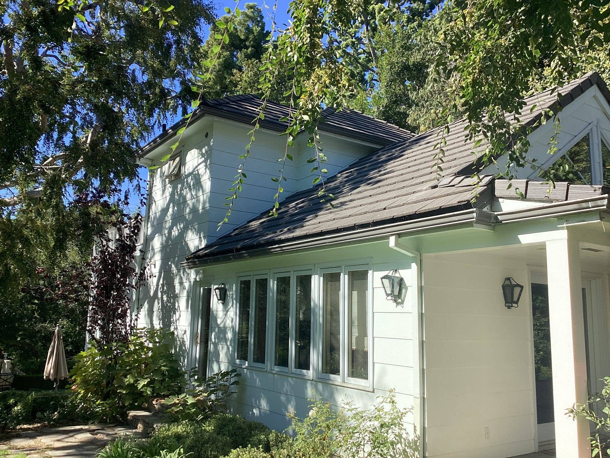 Light-colored home exterior with painted window trim