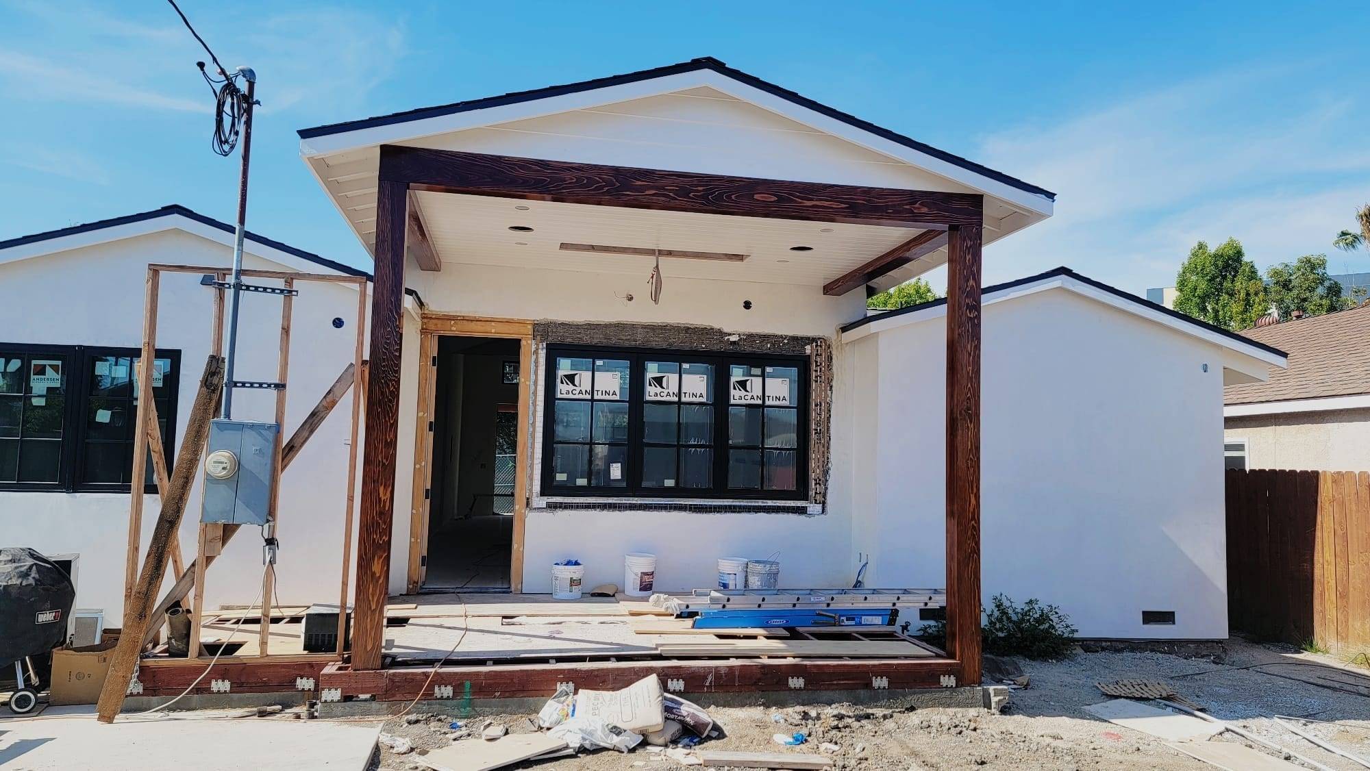 Small gabled building exterior during painting