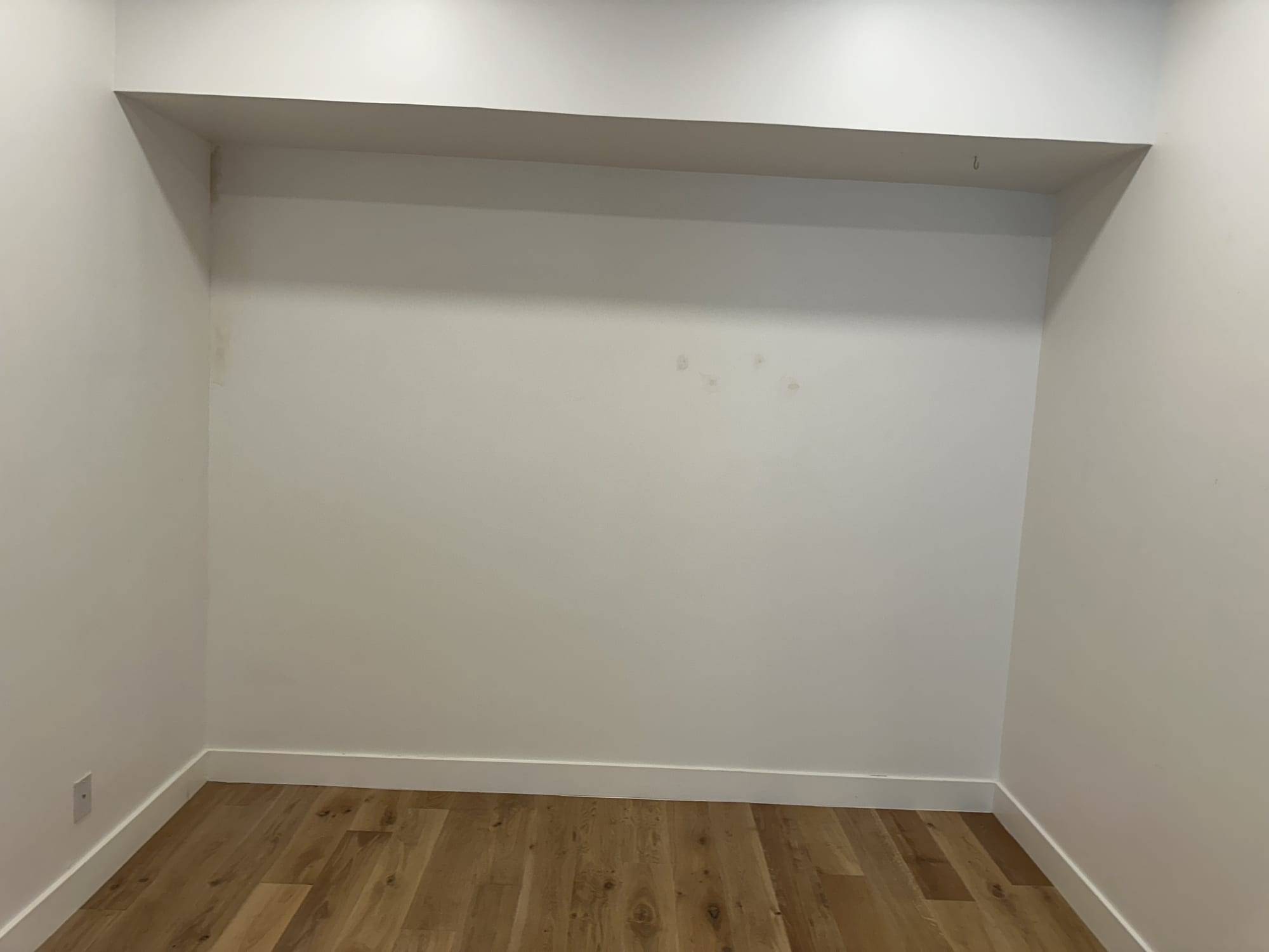Empty alcove with fresh white walls over a wood floor