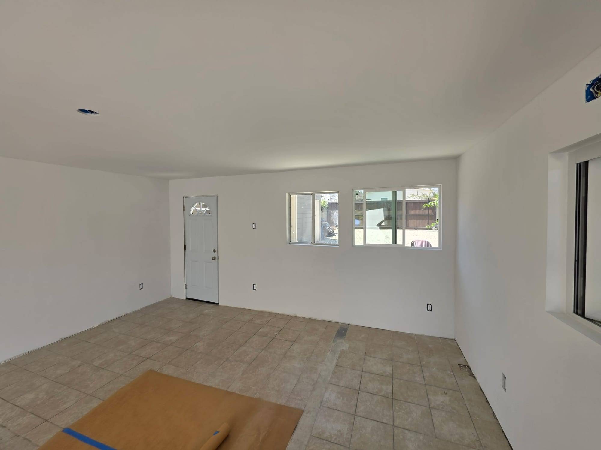 Empty room with fresh white walls, door view