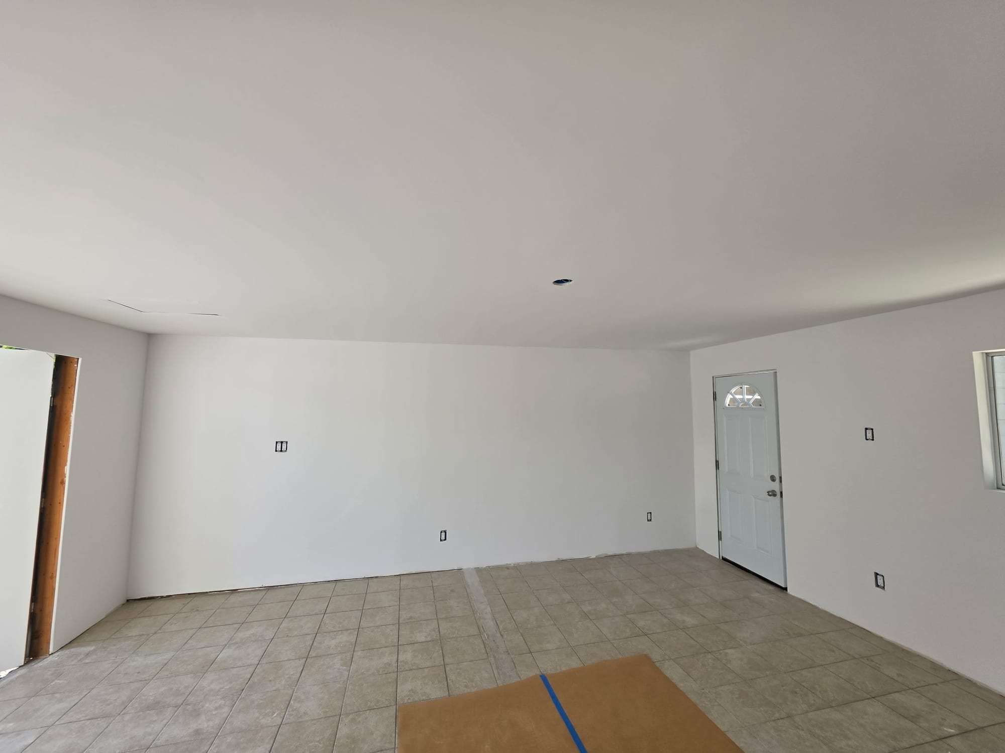 Empty room with fresh white walls, wide view