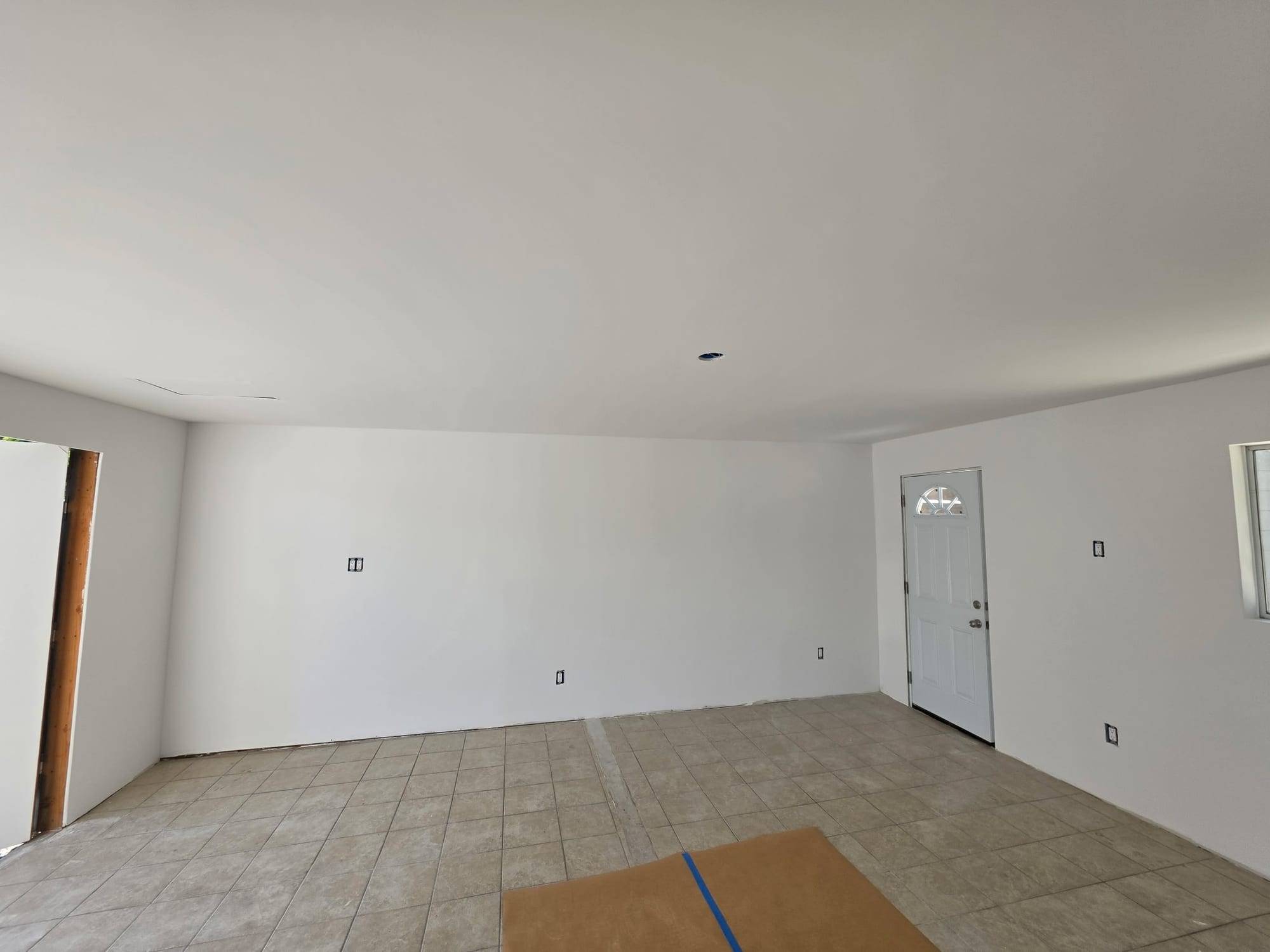 Empty room with fresh white walls, wide view