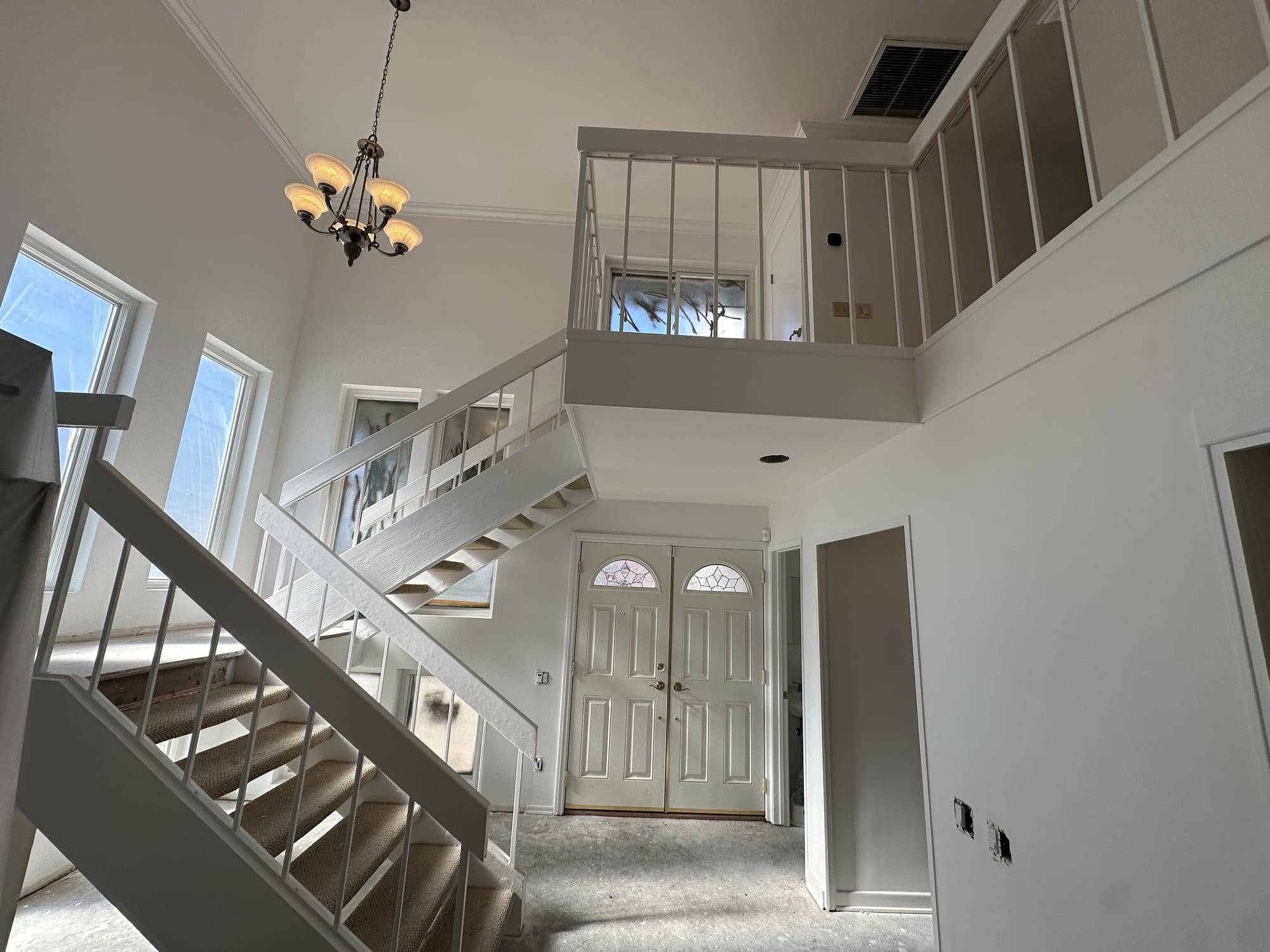 Entry hall and staircase with freshly painted walls and trim