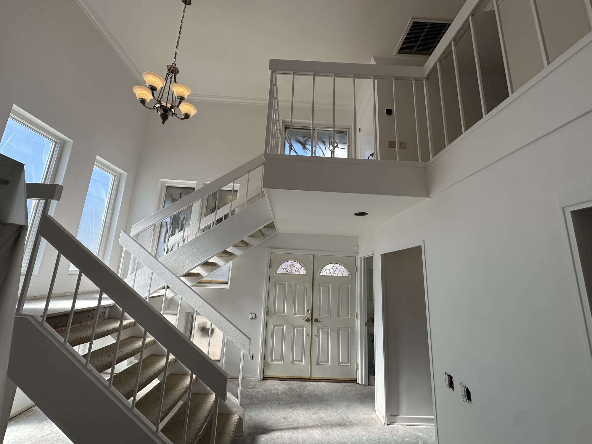 Entry hall and staircase with freshly painted walls and trim