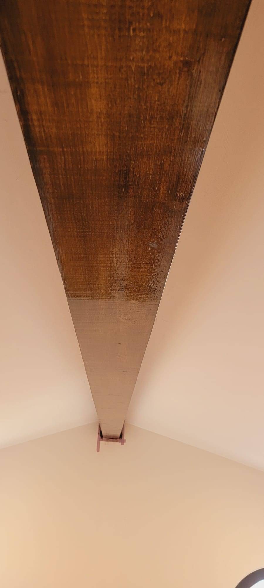 Stained exposed wood ceiling beam detail
