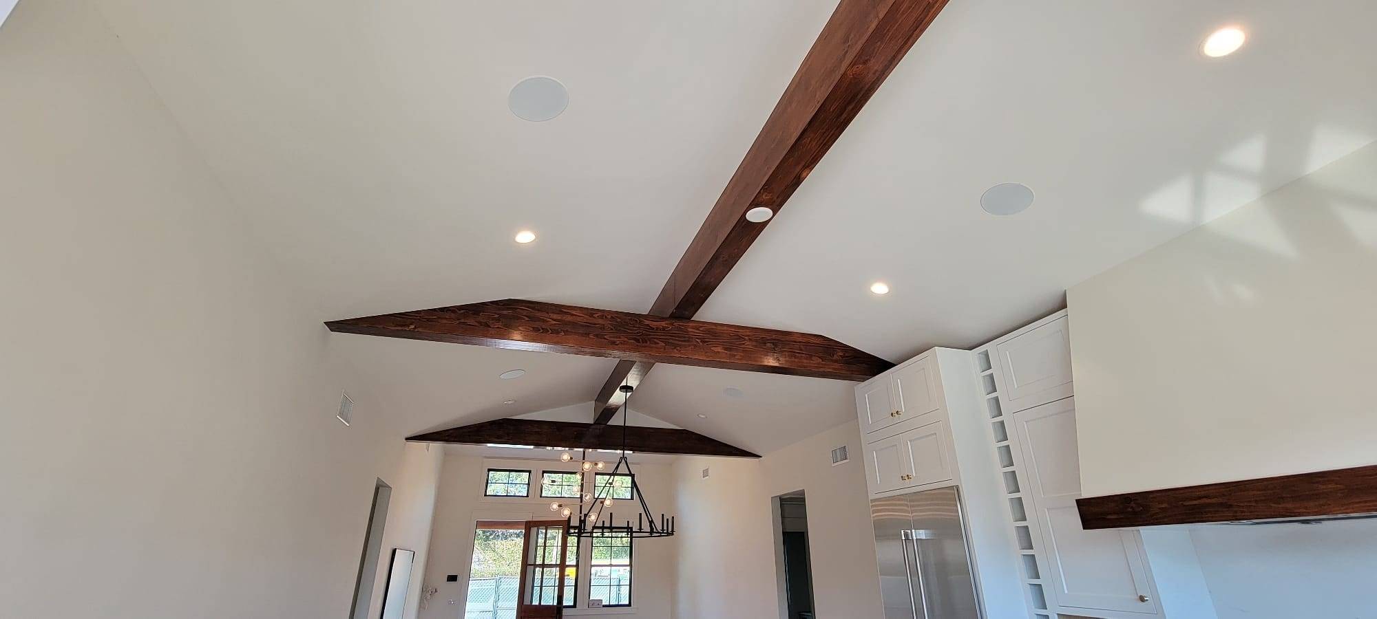Room with stained exposed wood ceiling beams