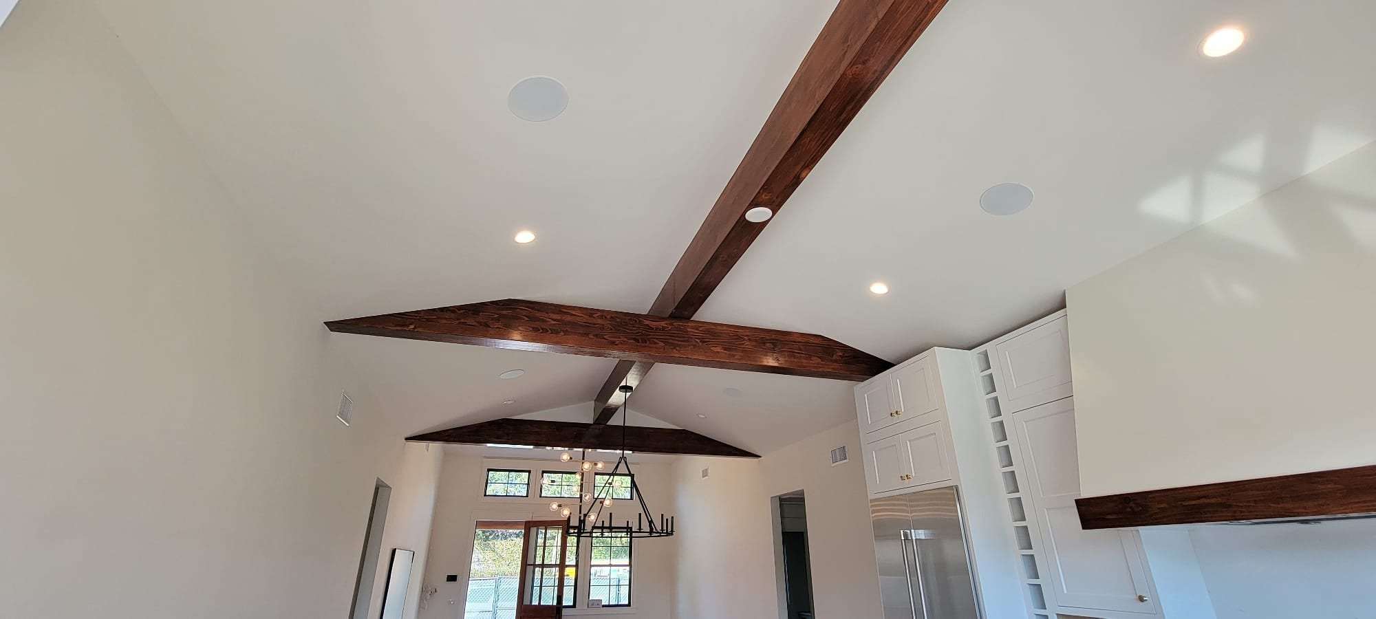 Room with stained exposed wood ceiling beams