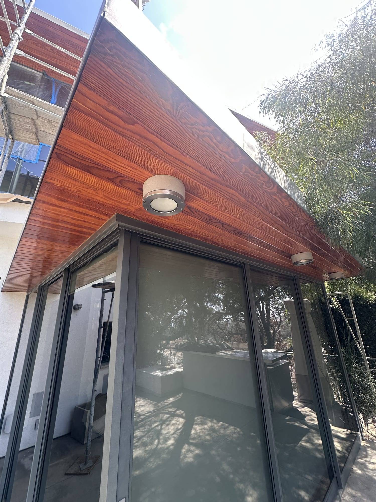 Stained wood soffit and fascia on a home exterior corner