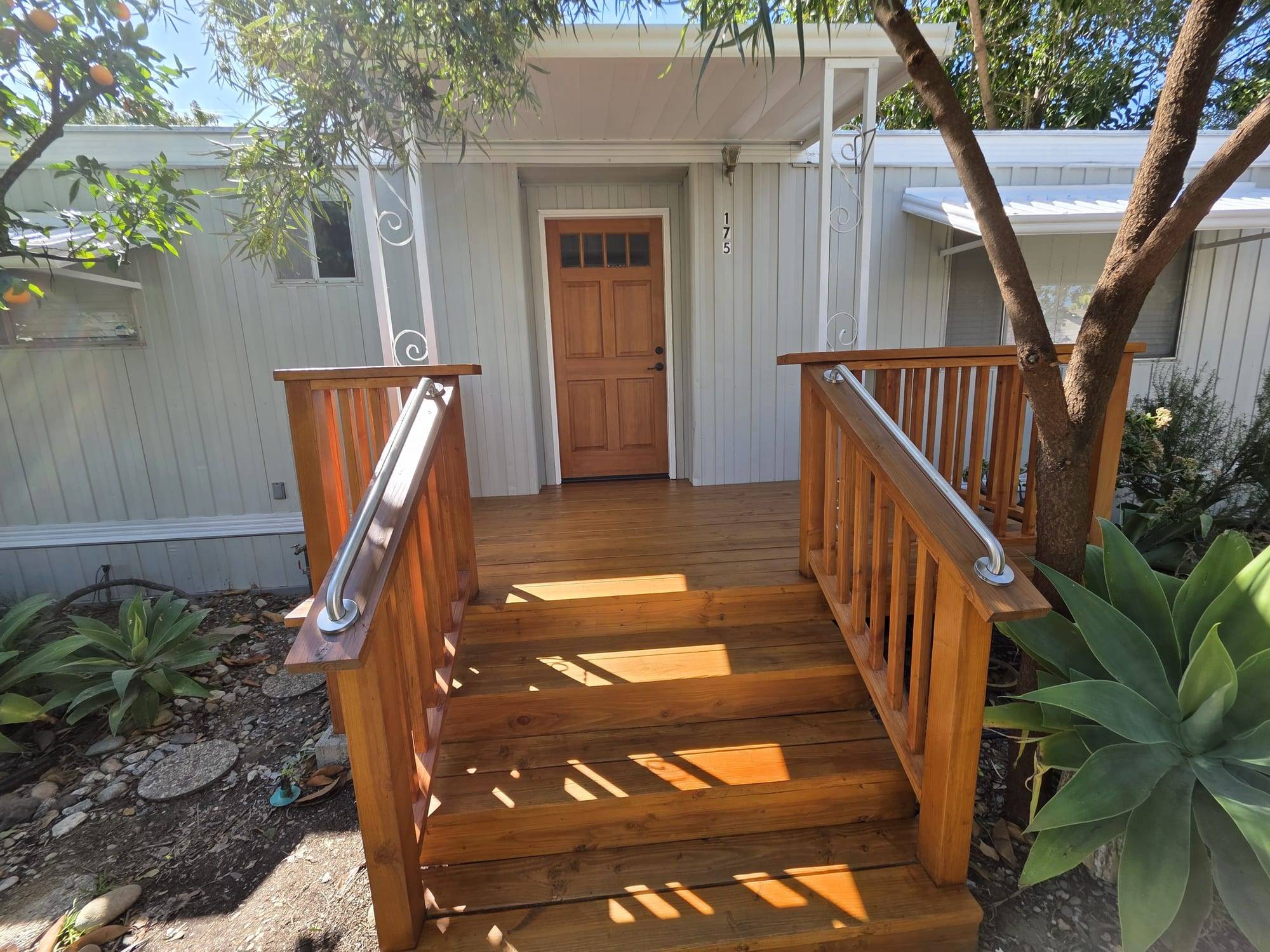 Stained wood porch steps, deck and handrails
